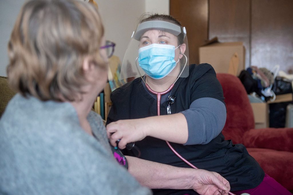 Cassie Bickford, CVHHH home care nurse, takes a patient's blood pressure at home