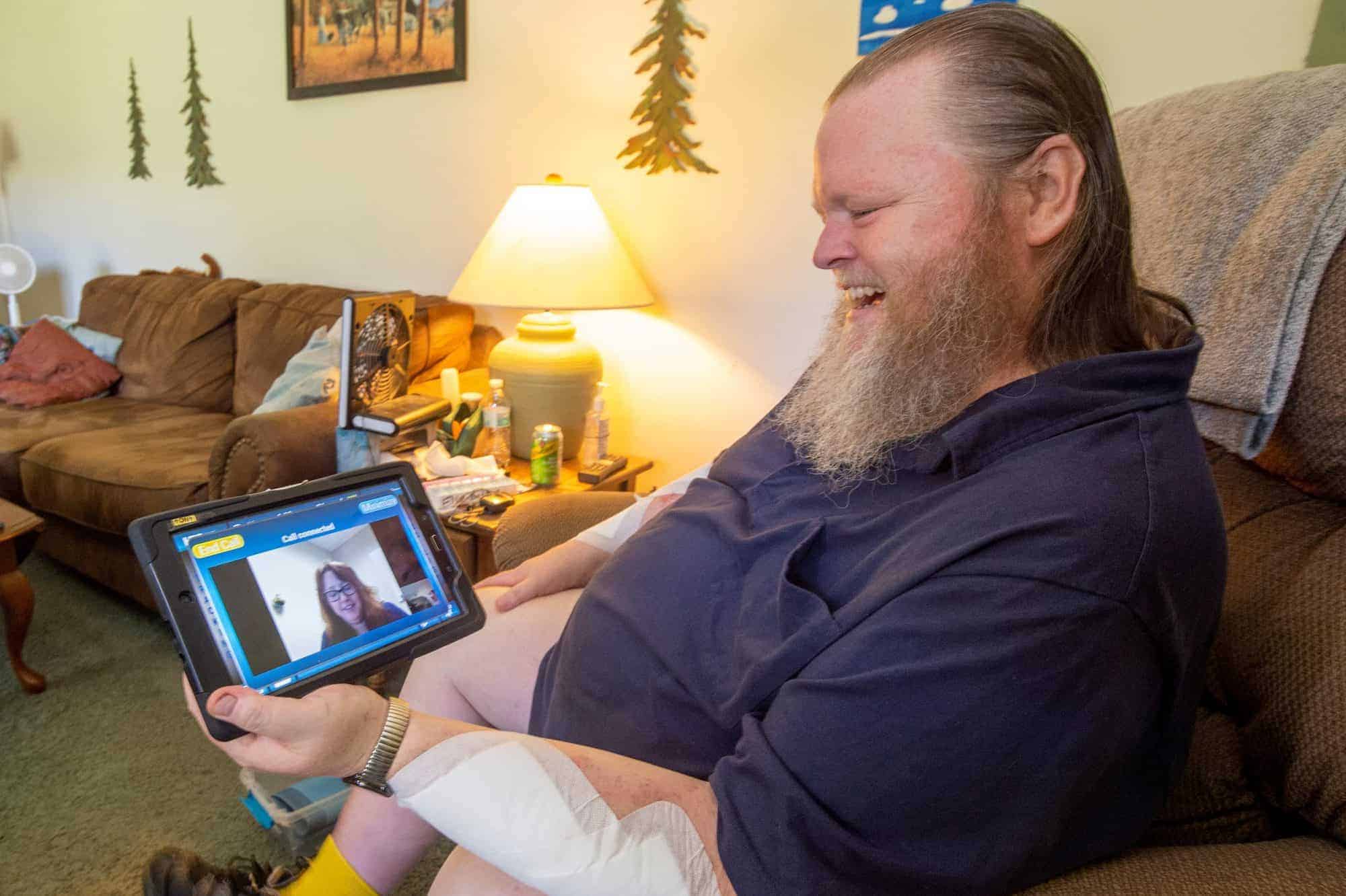 An image of a man meeting with an adult home care staff member