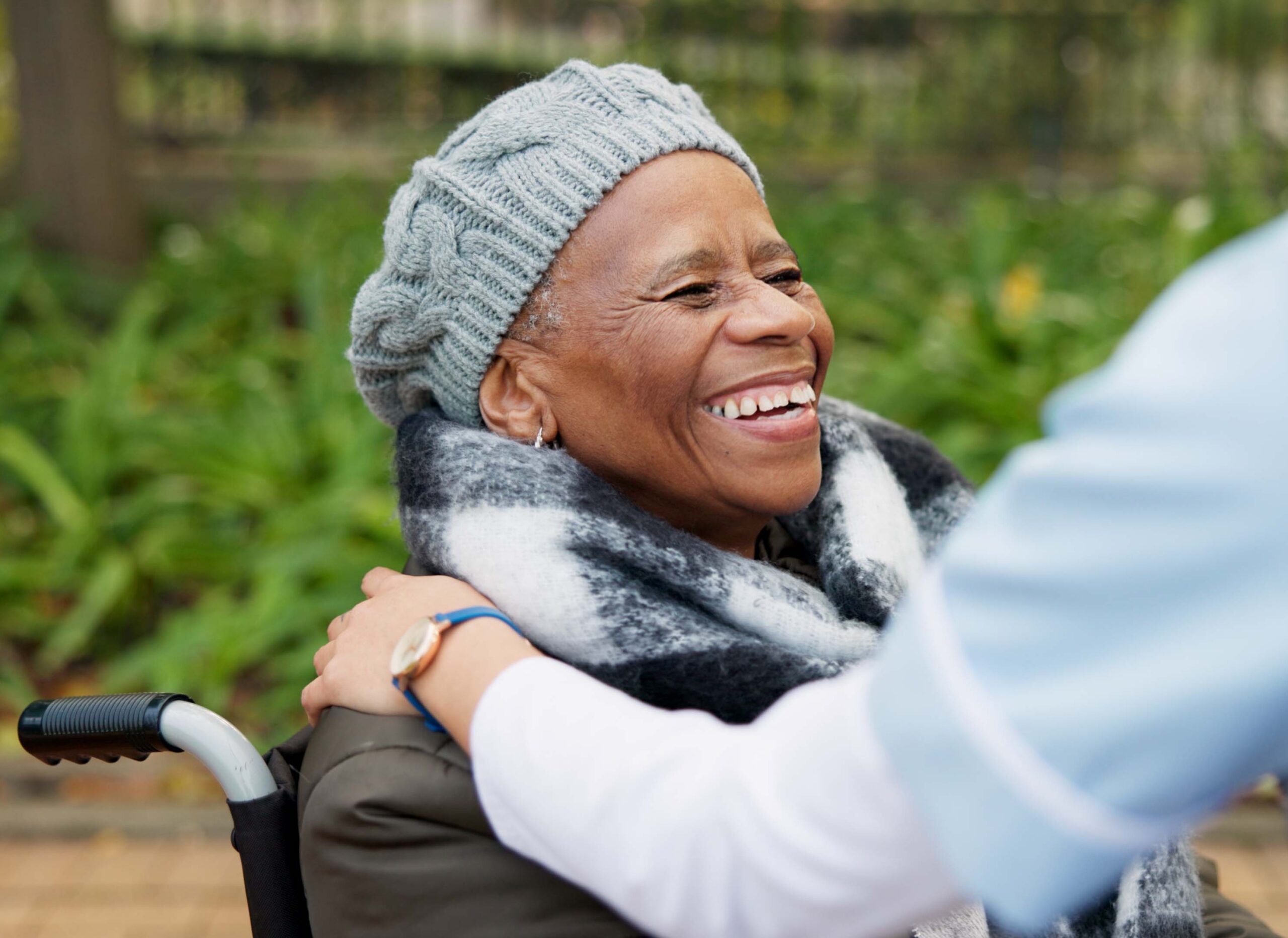 A smiling woman in a wheelchair