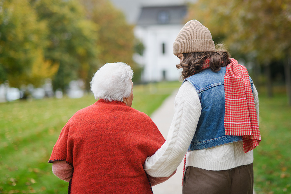 A CVHHH volunteer assisting an elderly patient